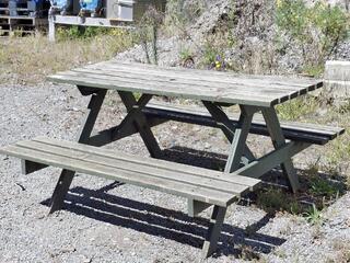 Outdoor wooden picnic table with attached benches